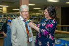 Stephen Levine, MD ’72 receives his boutonniere before the luncheon begins.