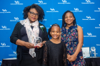 Marie-Anne Sanon Rosemberg, BS ’06, recipient of the 2022 Distinguished Alumni Award for the School of Nursing poses with her daughters. 