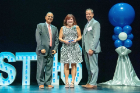 Kathleen Clark, CEL ’10, receives her award onstage with President Satish K. Tripathi (left) and Bank on Buffalo President Michael Noah (right). MidCity Office Furniture came in at number 44 on this year’s list.