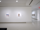 Installation photograph of Thinking in Indian at UB Anderson Gallery. We see two lit and framed works on a wall. 