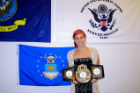 Kristen McMurtree, a UB Boxing Club member who attends D'Youville College in Buffalo, with the title belt she won at the 2015 Women's National Golden Gloves Tournament of Champions.