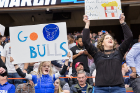 Coach Nate Oats' daughter and wife, Crystal, cheer on the Bulls with hand-made signs.
