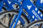 UB Bikeshare program bicycles emblazoned with the spirit mark and signature blue and white colors. 