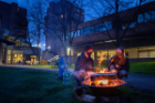 Student enjoy fire pits, hosted by the Student Association, outside the Ellicott Complex on an evening in April 2021.\r\rPhotographer: Meredith Forrest Kulwicki\r\rThis image has been approved by UBâs Office of Environment, Health and Safety to align with current health and safety regulations during the COVID-19 pandemic.