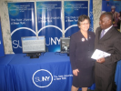 Individuals standing in front of the computer monitors at the SUNY booth at the 2011 Albany Caucus
