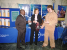 Individuals chatting in front of the SUNY booth at the 2011 Albany Caucus