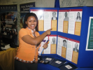 Woman pointing at an exhibit at the 2011 Albany Caucus