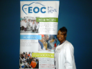 Person standing in front of an EOC banner 