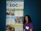 Person standing in front of an EOC banner 