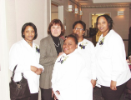 Four newly-pinned dental assisting students and faculty member pose for a group photo