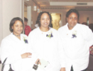 Three newly-pinned dental assisting students pose for a group photo