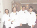 Four newly-pinned dental assisting students pose for a group photo