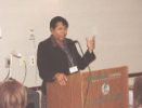 Woman presents at a podium 