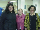 Dental assisting school student poses with two faculty members