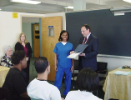 Dental Assisting school student receives an award while classmates and faculty members look on at 2010 Dental Pinning ceremony