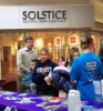 Visitors to the Dental Assisting School outreach table in the mall receive dental hygiene kits