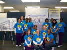 Dental Assisting school students pose in front of EOC display