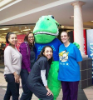 Individuals pose with the ADA mascot at the mall