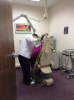 Dental assistant student working on patient sitting in dental chair
