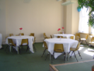 empty tables with tablecloths in a room