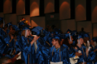 Graduates cheer from the audience