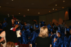 Graduates cheer from the audience
