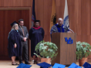 Faculty member addresses waiting graduates