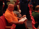 Audience member consults their program