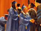 Two graduates receive their degrees