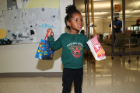 Child with popcorn and goodie bag