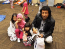 adult with kids in costumes