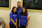 three adults with UB educational opportunity center t-shirts