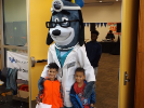 Two boys pose with Doctor Dog mascot
