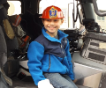Boy sitting in fire truck