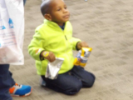 Boy kneels with snacks