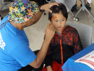 Volunteer paints child's face
