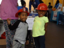 Two kids in fireman's hats