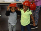 Two children in fireman's hats