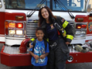 Firefighter and child in front of truck
