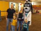 Family with 3 kids pose with mascot