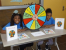Volunteers with Win a Prize wheel