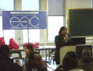 person presenting in a room with EOC banner in background