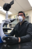Artist-in-Residence Cesar Baio filming slime mold through a microscope, 2020.