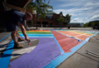 Members of the facilities team work to paint a new rainbow crosswalk design near the Student Union and UB Commons in August 2019. The Office of Inclusive Excellence helped organize the design and effort. Photographer: Meredith Forrest Kulwicki