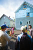 Peter Russell (left) and Ed Steinfeld lead University at Buffalo students on a tour of a Habitat for Humanity house designed by UB students. The design allows for a lift to be retrofitted on the back of the house to permit aging in place.