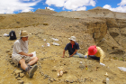 Liu (far right) and colleagues Gary Takeuchi (center) and Z. Jack Tseng working in the field in the newly discovered site in Zanda Basin.