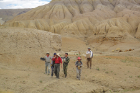 Liu (red hat) and her colleagues retrieve fossils from a deep gulley back to camp.
