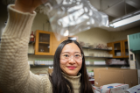 UB chemistry master's student Xiaotong Zhang holds a crystal. Credit: Douglas Levere / University at Buffalo