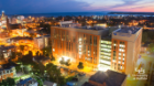 A nighttime aerial view of Jacobs School of Medicine and Biomedical Sciences
