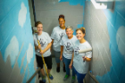 From left: Lauren Maynard, Estella Johnson, Ann Williams and Olga Chrombie paint a stairwell at the Gloria J. Parks Community Center. Photo: Douglas Levere